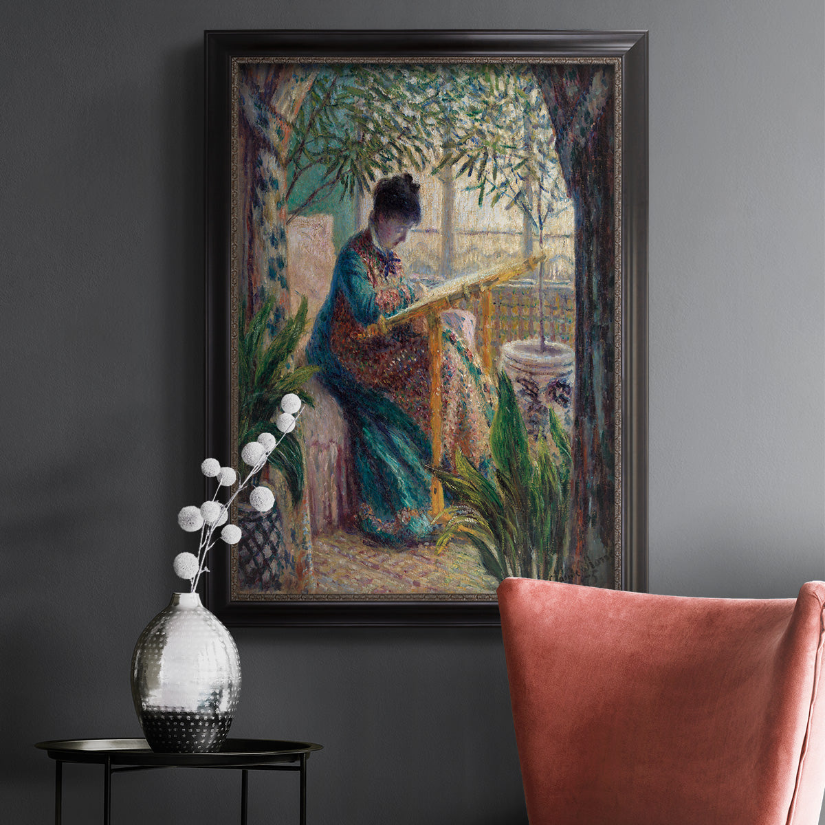 Impressionist portrait of Madame Monet sewing by Claude Monet in an ornate black frame with gilded inner detail displayed in a dark-toned interior setting.