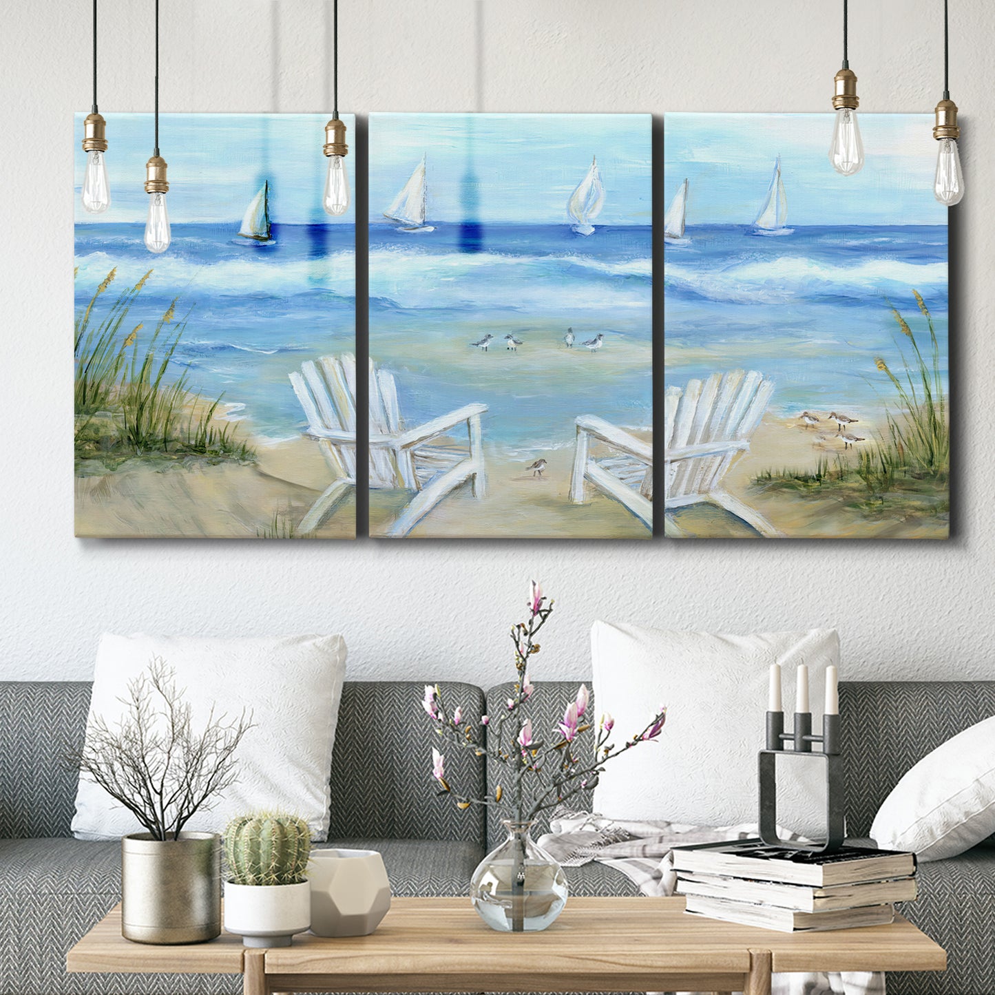 Three-panel canvas wall art featuring peaceful coastal landscape escape, displayed in a modern living room above seating.
