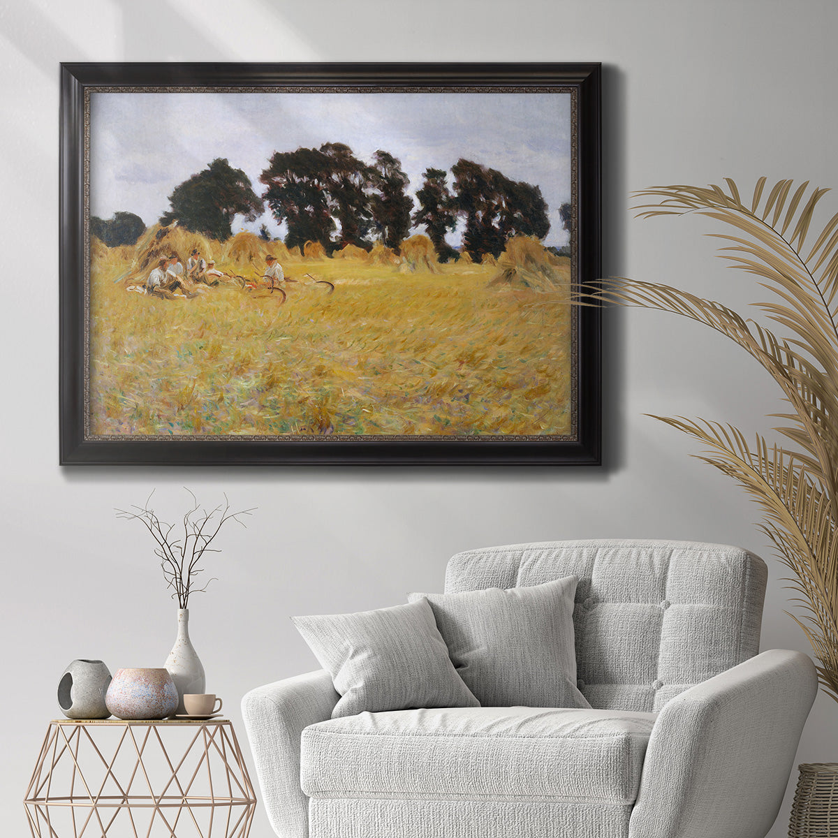 Impressionist rural harvest scene by John Singer Sargent in an ornate black frame with gilded inner detail displayed in a bright interior setting.