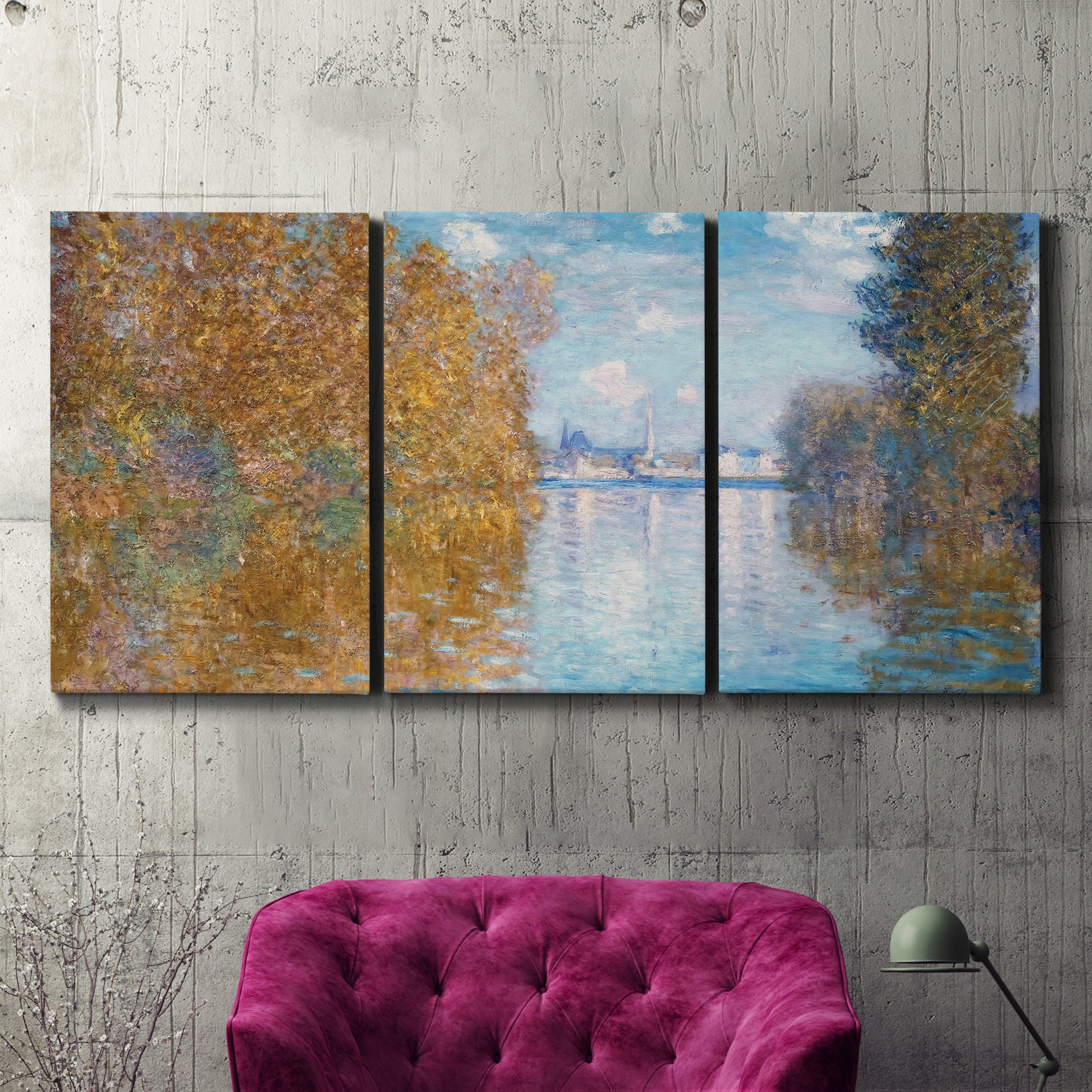 Three-panel canvas wall art featuring autumn landscape with glowing foliage, displayed in a living room above a suede accent chair.