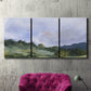 Three-panel canvas wall art featuring wide open pastoral horizon landscape, displayed in a living room above a suede accent chair.
