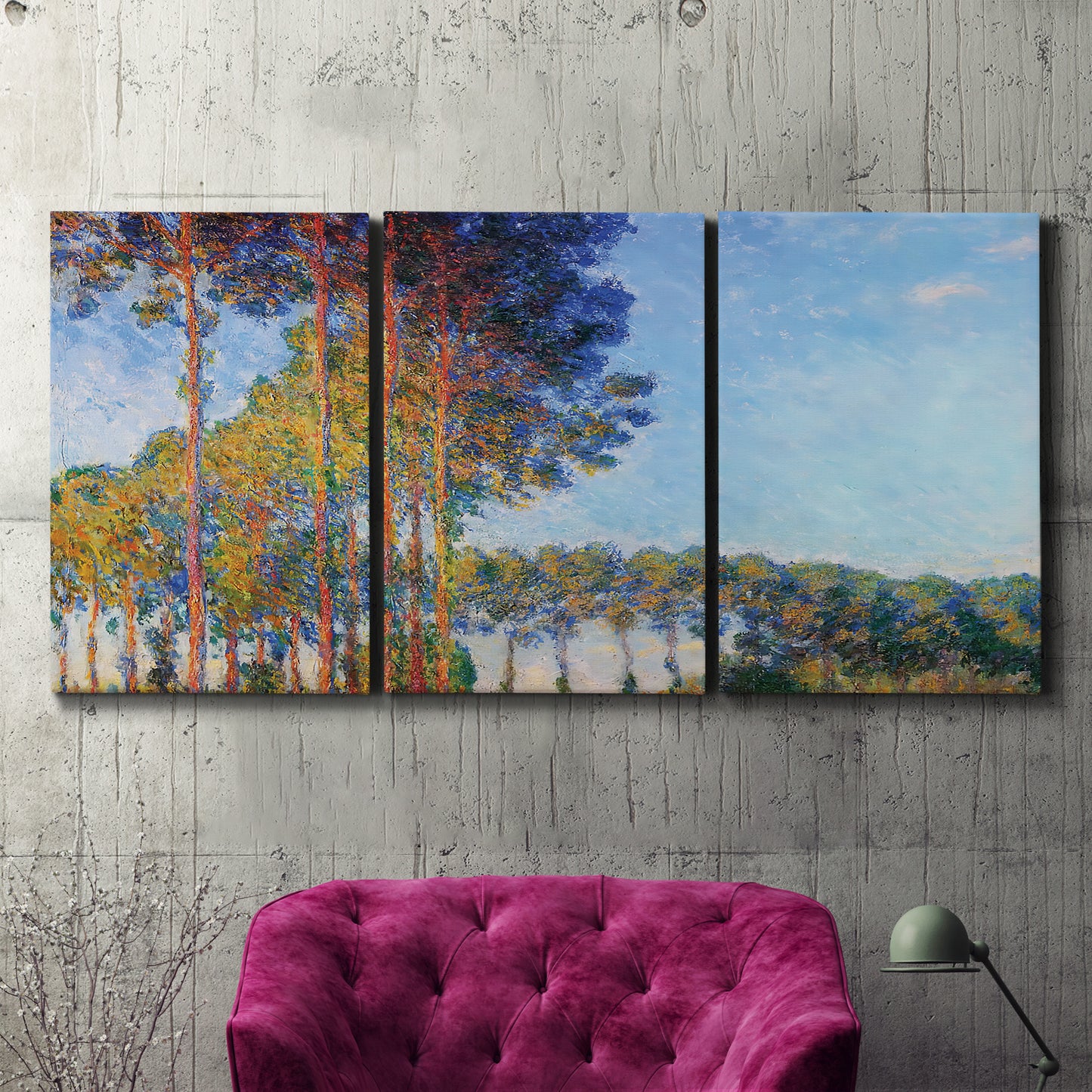 Three-panel canvas wall art featuring autumn poplar trees along river, displayed in a living room above a suede accent chair.