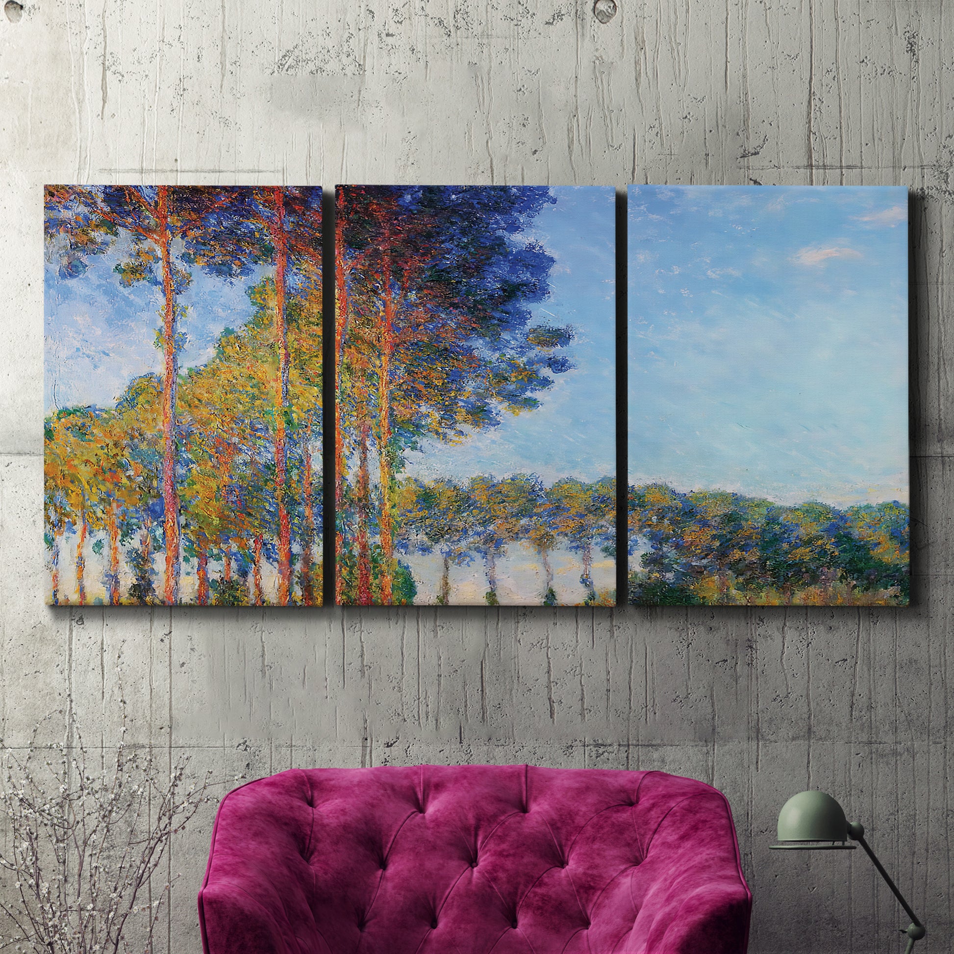 Three-panel canvas wall art featuring autumn poplar trees along river, displayed in a living room above a suede accent chair.