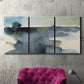 Three-panel canvas wall art featuring abstract watercolor with upward motion, displayed in a living room above a suede accent chair.