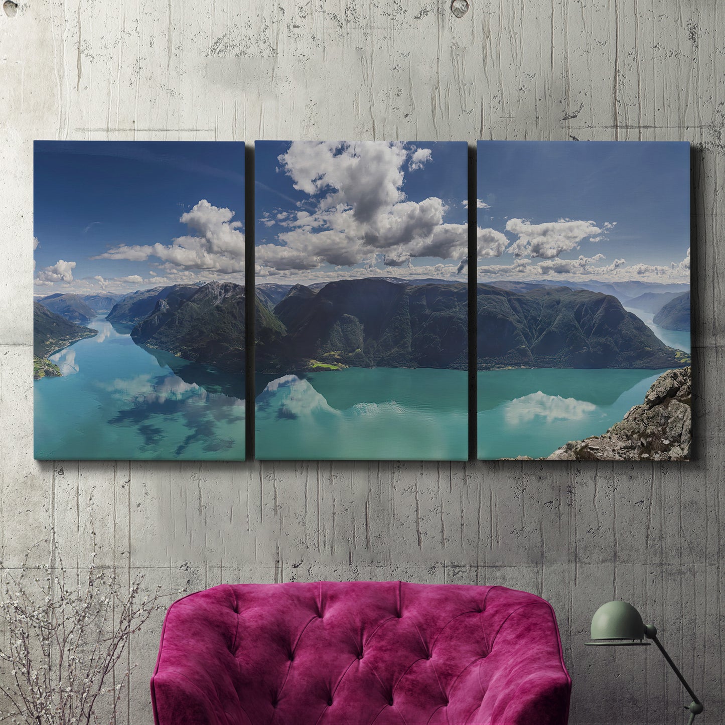 Three-panel canvas wall art featuring tropical water reflections with foliage, displayed in a living room above a suede accent chair.