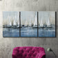 Three-panel canvas wall art featuring still life with pears and grapes, displayed in a living room above a suede accent chair.