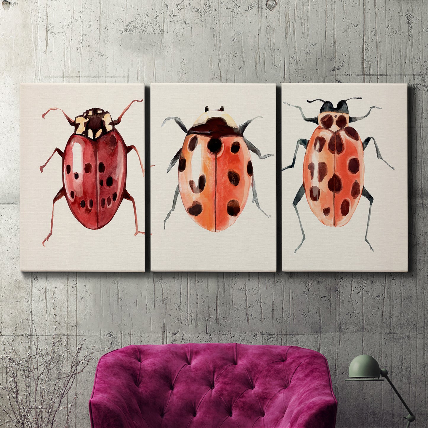 Three-panel canvas wall art featuring ladybugs on green foliage, displayed in a living room above a suede accent chair.