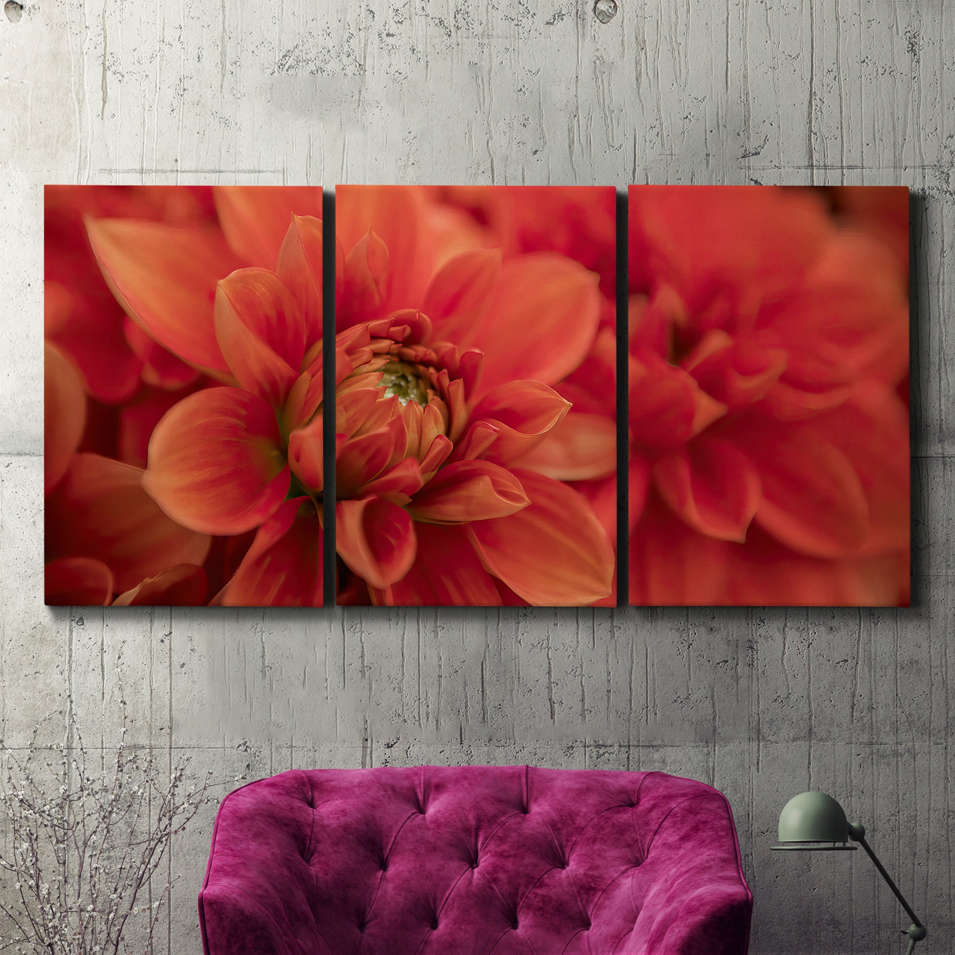 Three-panel canvas wall art featuring vivid red floral close up, displayed in a living room above a suede accent chair.