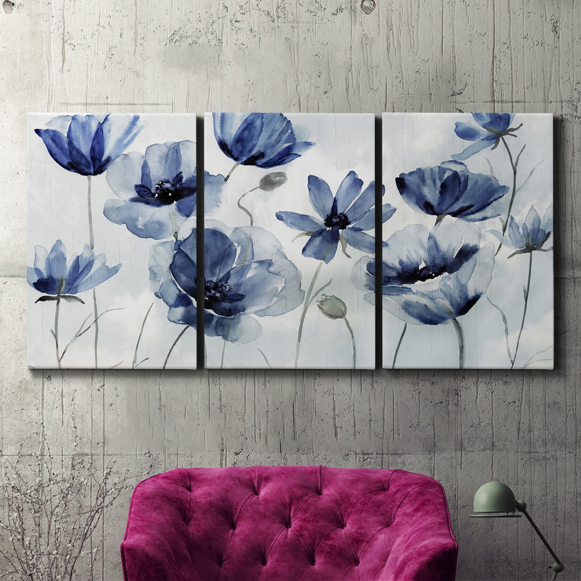 Three-panel canvas wall art featuring indigo floral blossoms awakening, displayed in a living room above a suede accent chair.
