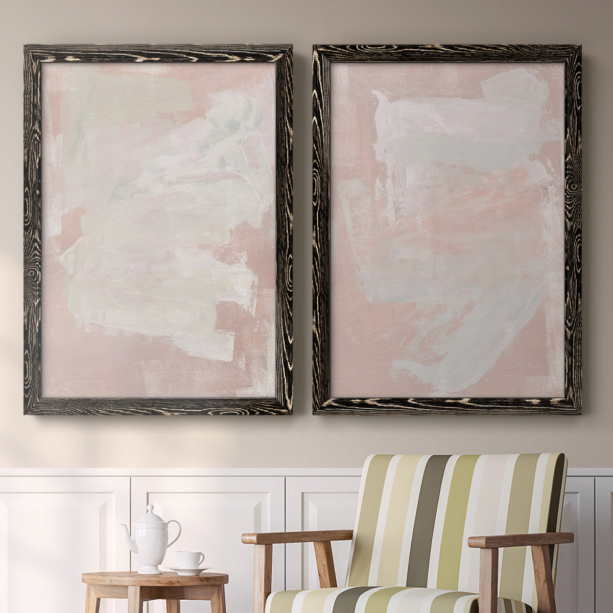 Set of two black barnwood framed canvas prints depicting two minimalist color-field abstracts featuring soft blush and white painterly fields above a sideboard in a cozy sitting room.