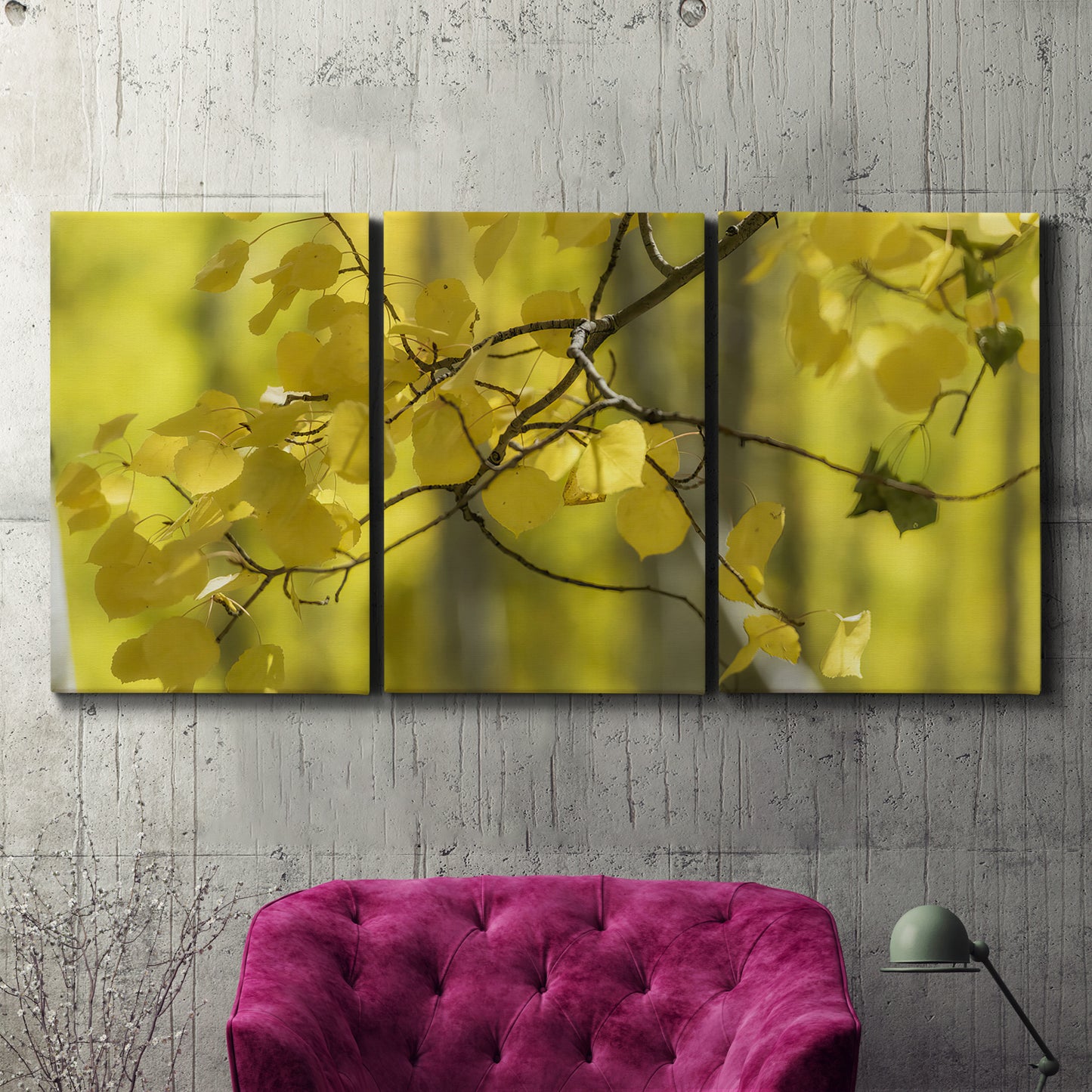 Three-panel canvas wall art featuring backlit aspen trees photograph, displayed in a living room above a suede accent chair.
