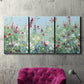 Three-panel canvas wall art featuring night landscape silhouette photography, displayed in a living room above a suede accent chair.