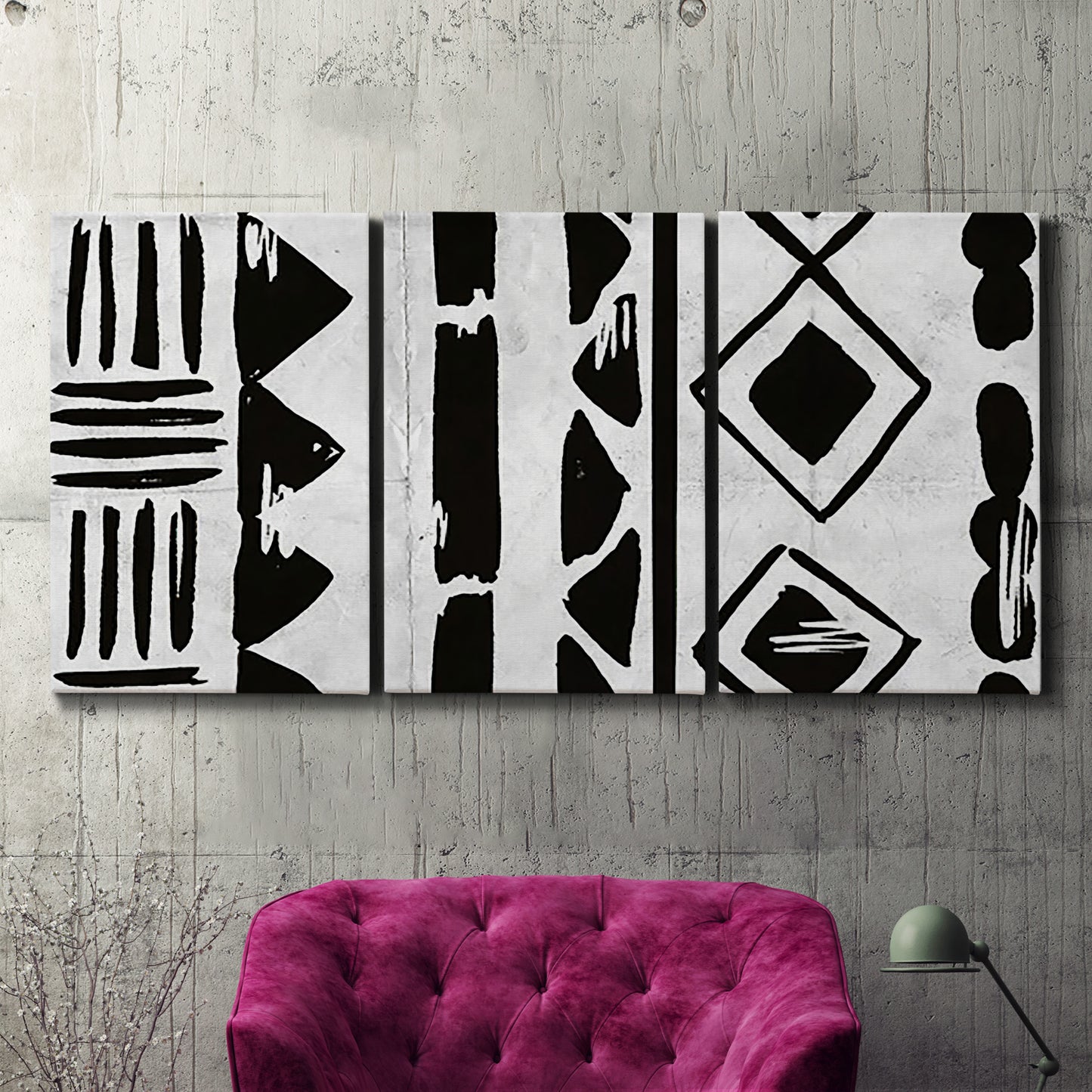 Three-panel canvas wall art featuring geometric abstract forms merging pattern, displayed in a living room above a suede accent chair.