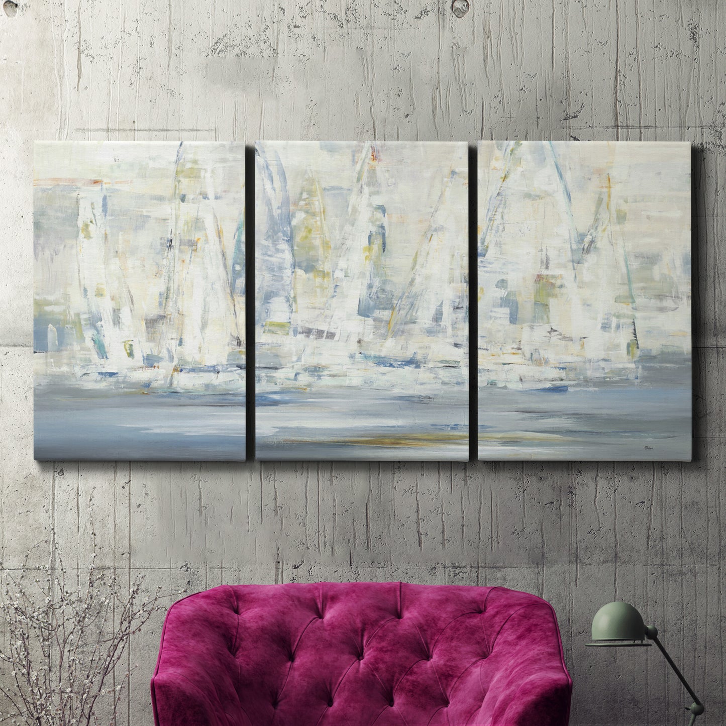Three-panel canvas wall art featuring impressionist regatta scene with sailboats, displayed in a living room above a suede accent chair.