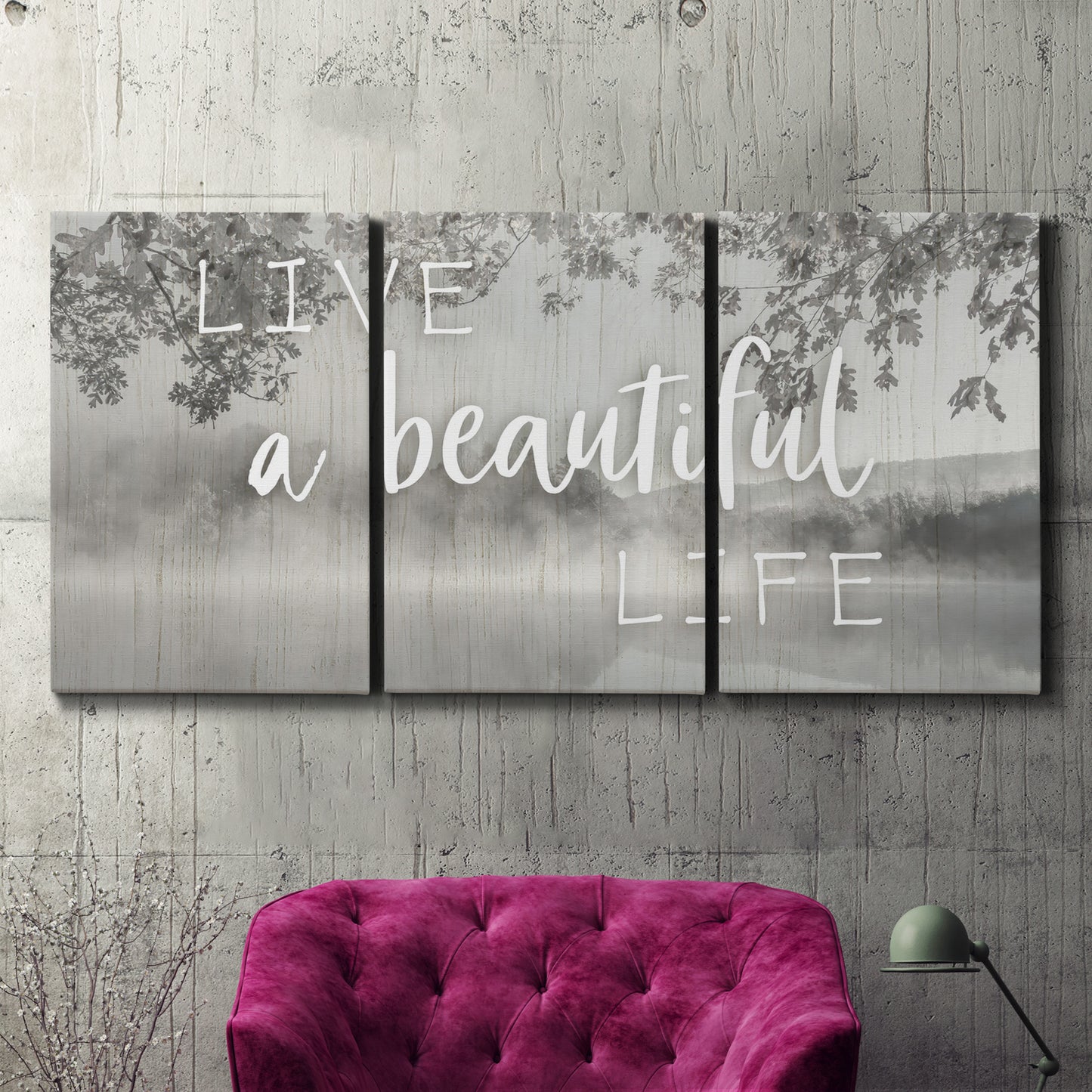 Three-panel canvas wall art featuring uplifting life themed typography, displayed in a living room above a suede accent chair.