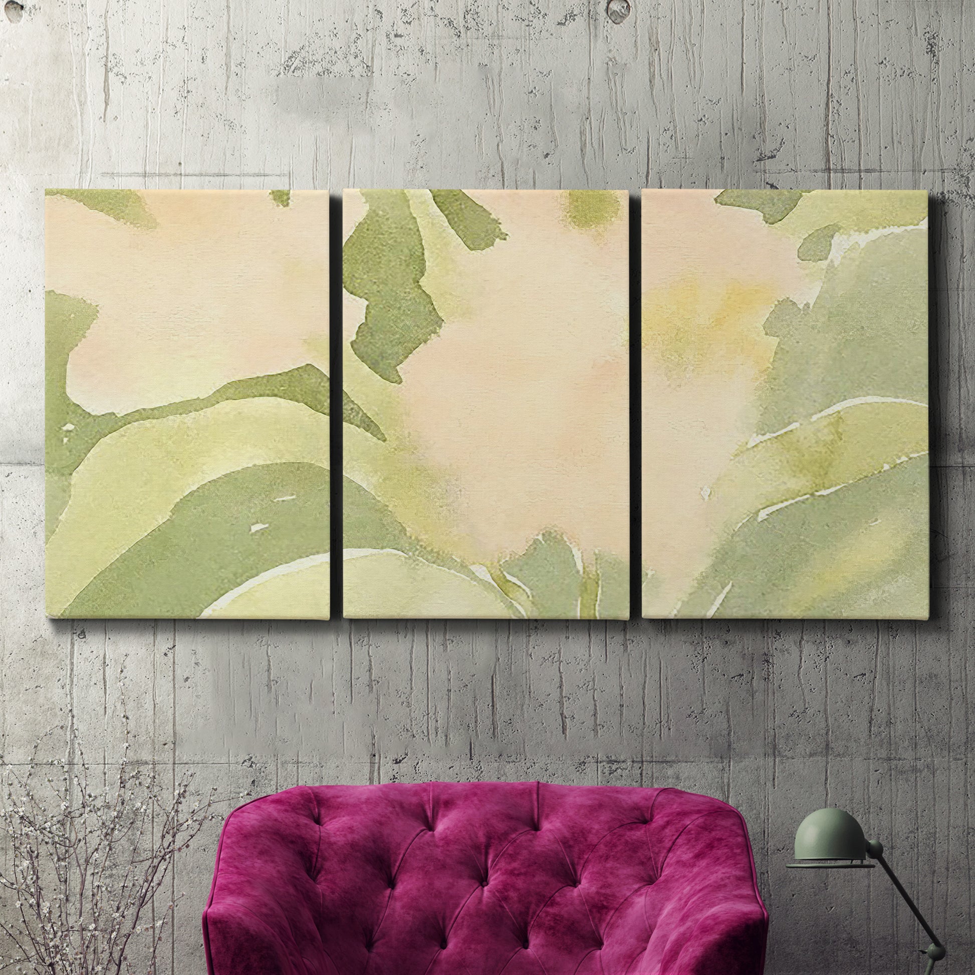 Three-panel canvas wall art featuring minimal verdant floral abstraction, displayed in a living room above a suede accent chair.