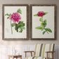 Set of two walnut barnwood framed canvas prints depicting two vintage botanical plate illustrations featuring pink flowering plant specimens above a sideboard in a cozy sitting room.