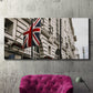 Three-panel canvas wall art featuring london street scene photograph, displayed in a living room above a suede accent chair.