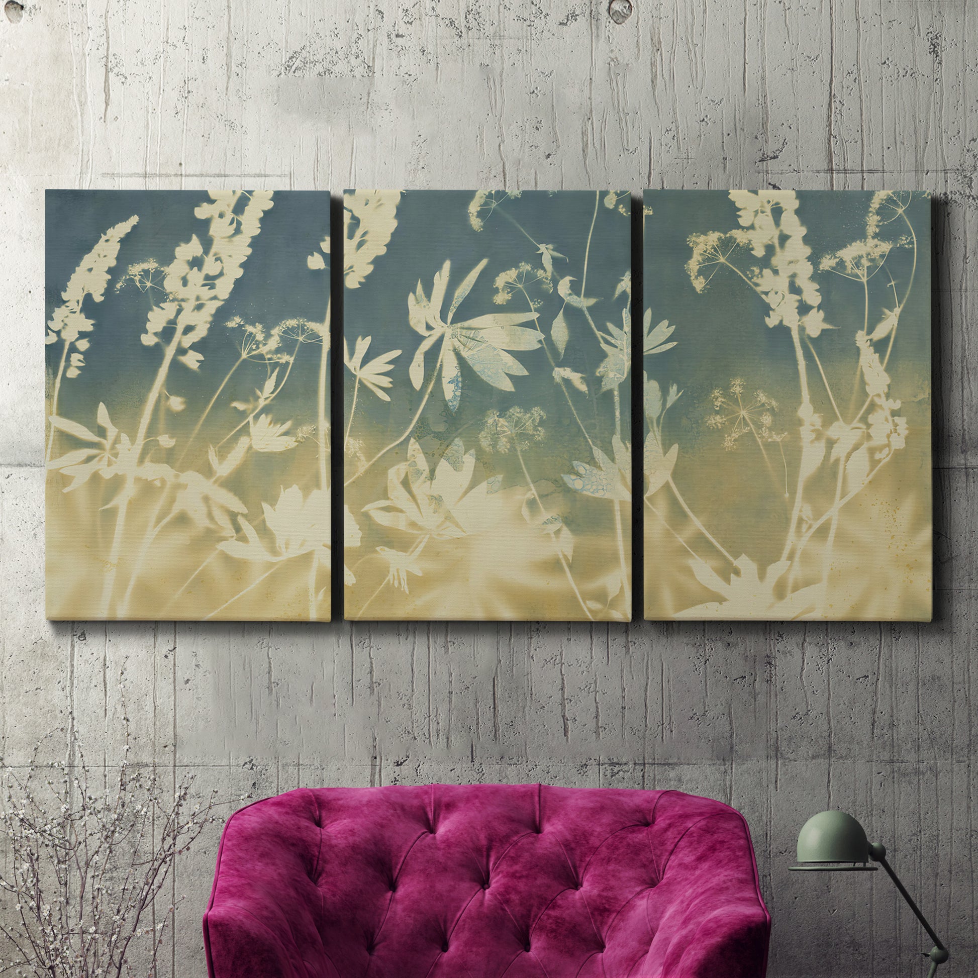Three-panel canvas wall art featuring lupine flowers in seasonal bloom, displayed in a living room above a suede accent chair.