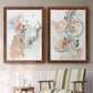 Set of two maple barnwood framed canvas prints depicting two abstract watercolor botanicals featuring loose blush gray and coral floral gestures above a sideboard in a cozy sitting room.