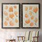 Set of two black barnwood framed canvas prints depicting two airy watercolor floral paintings featuring loose peach-orange tulip-like blossoms above a sideboard in a cozy sitting room.