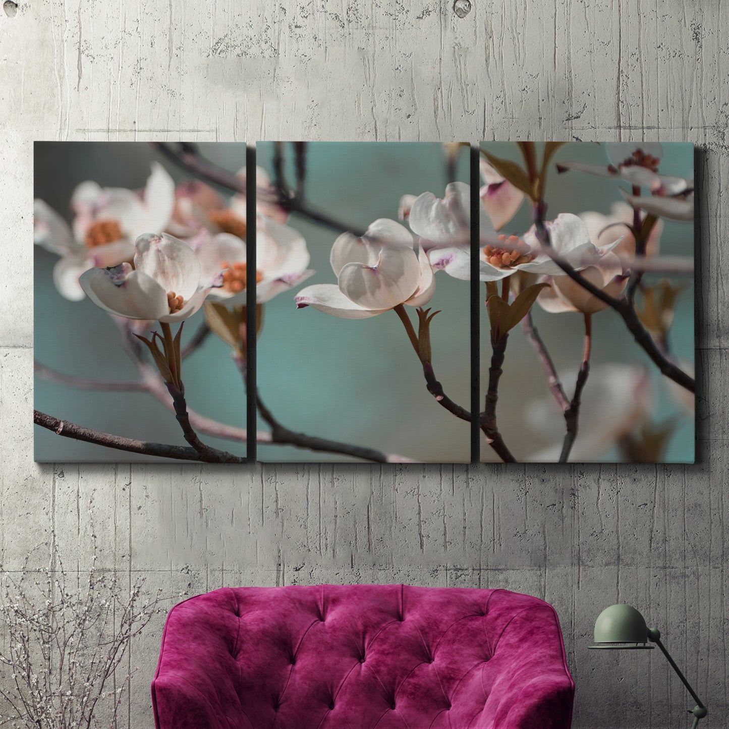 Three-panel canvas wall art featuring dogwood blossoms in spring photograph, displayed in a living room above a suede accent chair.