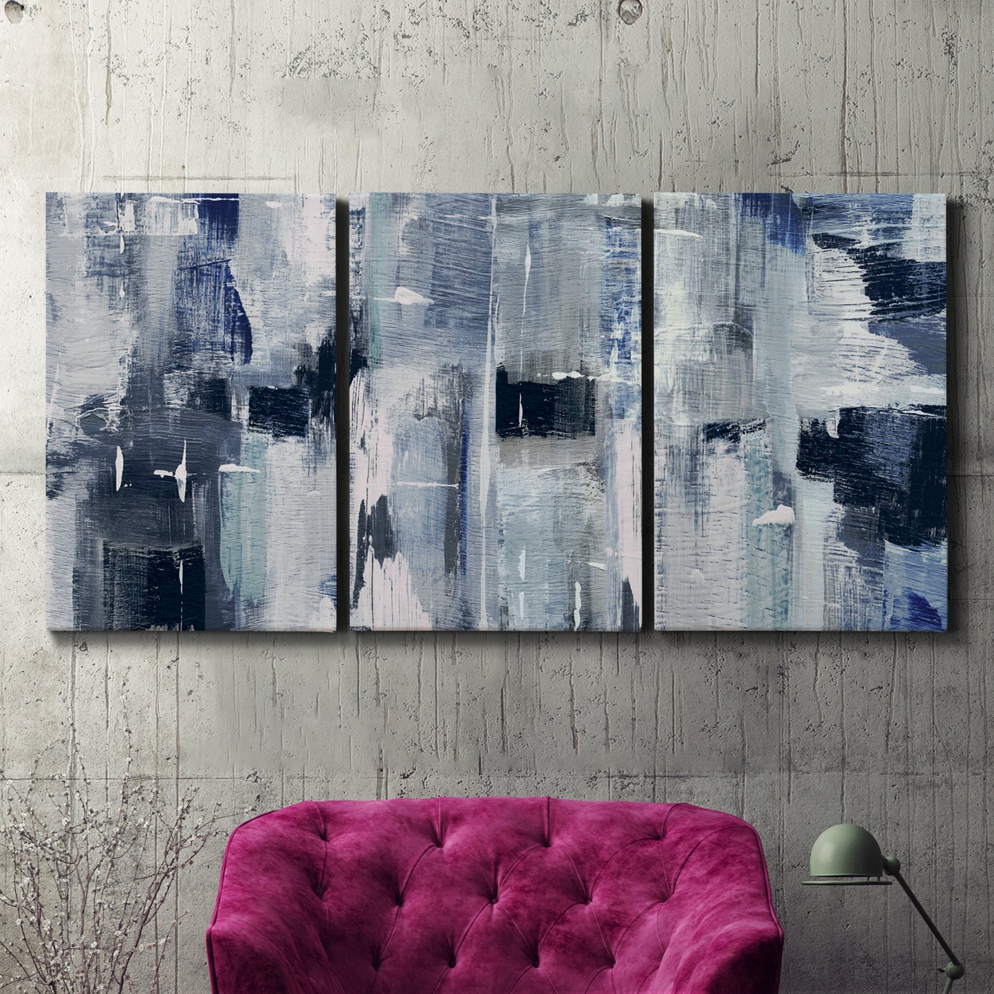 Three-panel canvas wall art featuring soft abstract mountain color fields, displayed in a living room above a suede accent chair.