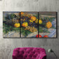 Three-panel canvas wall art featuring still life with pears and grapes, displayed in a living room above a suede accent chair.