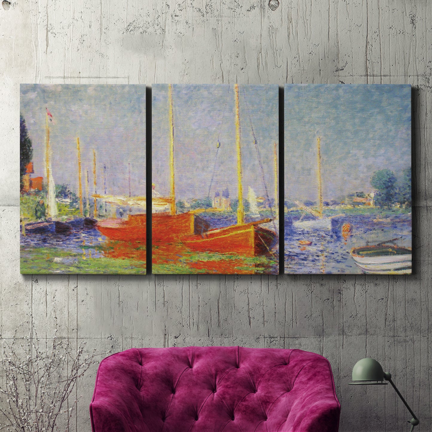 Three-panel canvas wall art featuring red boats along riverbank, displayed in a living room above a suede accent chair.