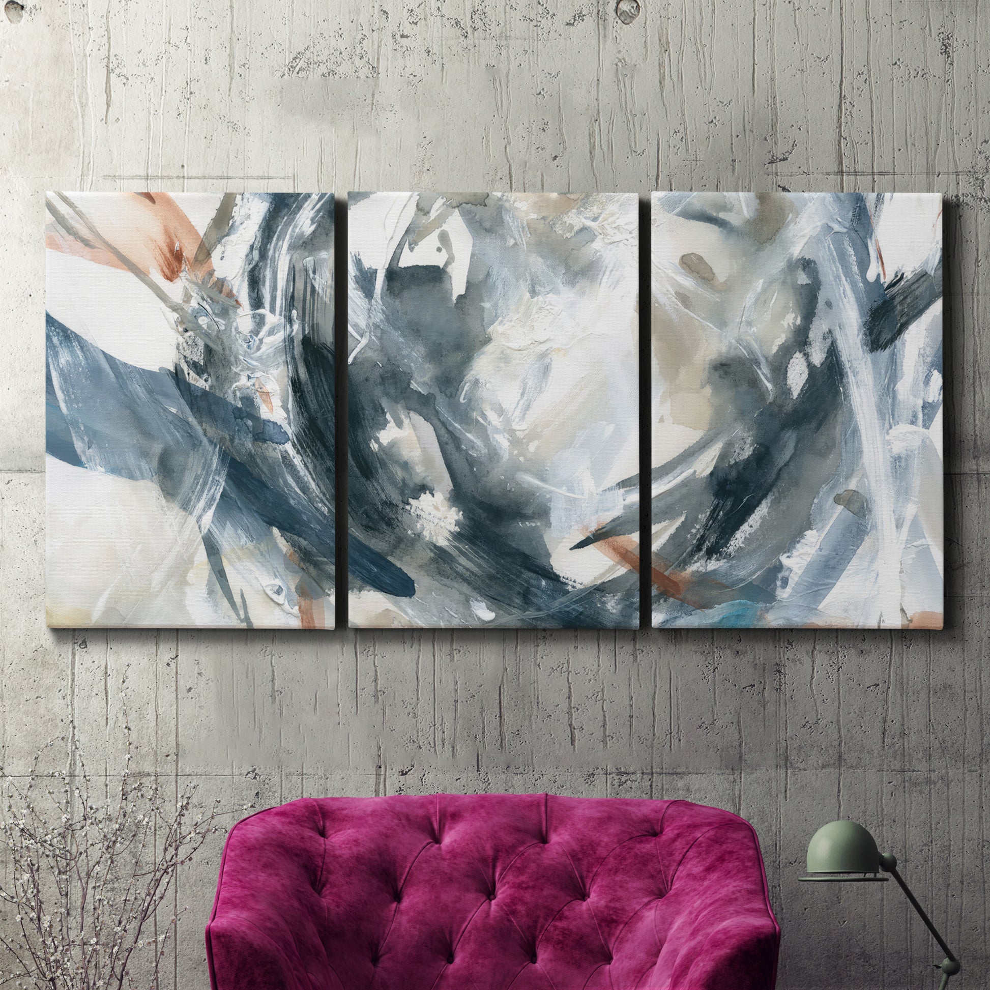 Three-panel canvas wall art featuring repeating abstract geometric array, displayed in a living room above a suede accent chair.