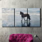 Three-panel canvas wall art featuring running horses captured mid stride, displayed in a living room above a suede accent chair.