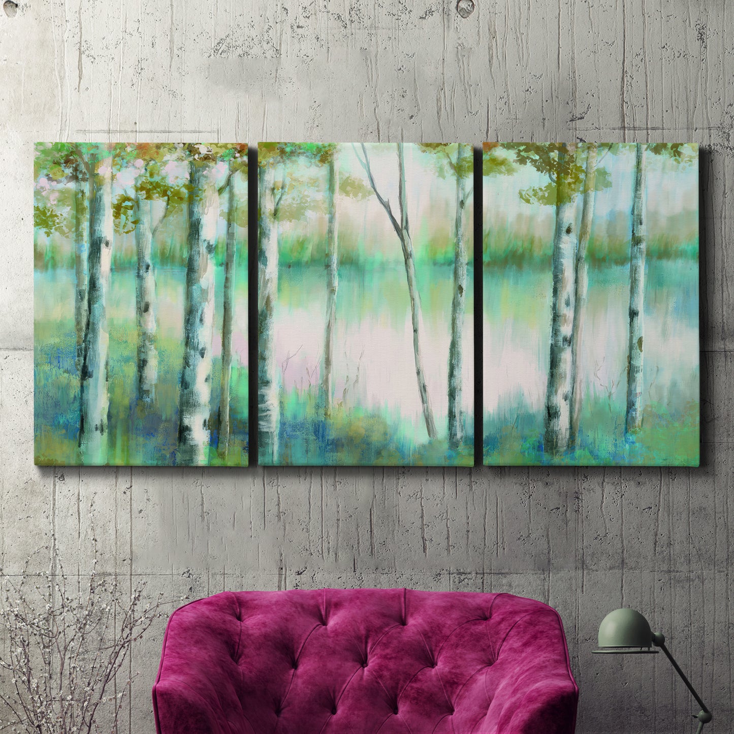 Three-panel canvas wall art featuring calm lake framed by aspen trees, displayed in a living room above a suede accent chair.