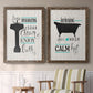 Set of two walnut barnwood framed canvas prints depicting two graphic bathroom word art featuring playful bathtub silhouettes and bath-themed typography above a sideboard in a cozy sitting room.