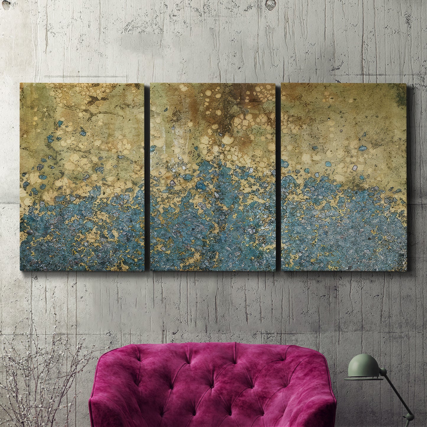 Three-panel canvas wall art featuring metallic abstract gold tones, displayed in a living room above a suede accent chair.