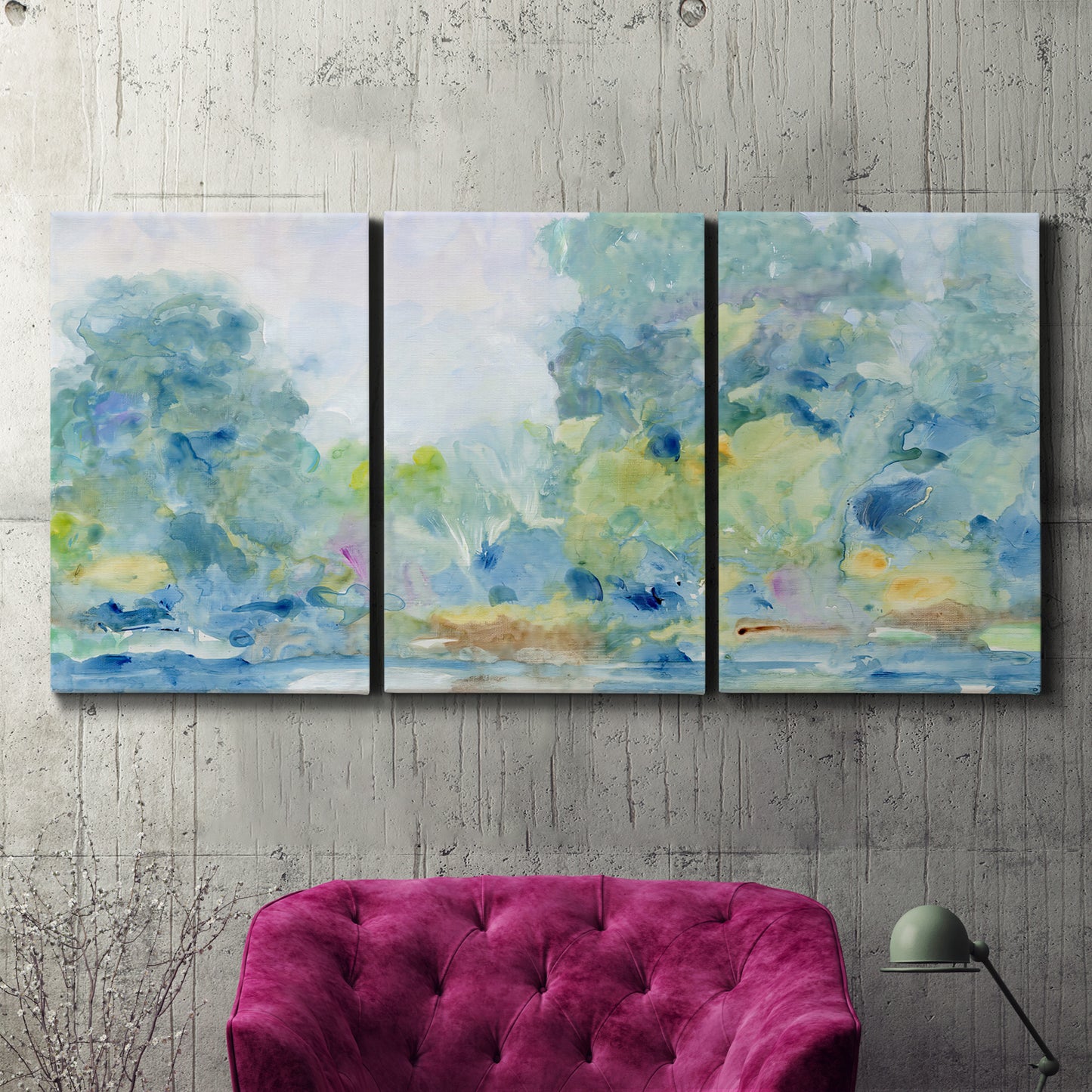 Three-panel canvas wall art featuring quiet abstract morning landscape, displayed in a living room above a suede accent chair.