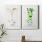 Pair of portrait canvas prints featuring vintage martini cocktail illustration displayed in a light, minimalist interior.