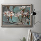 Close-up dogwood blossom photography in an ornate vintage silver frame displayed in a neutral interior setting.