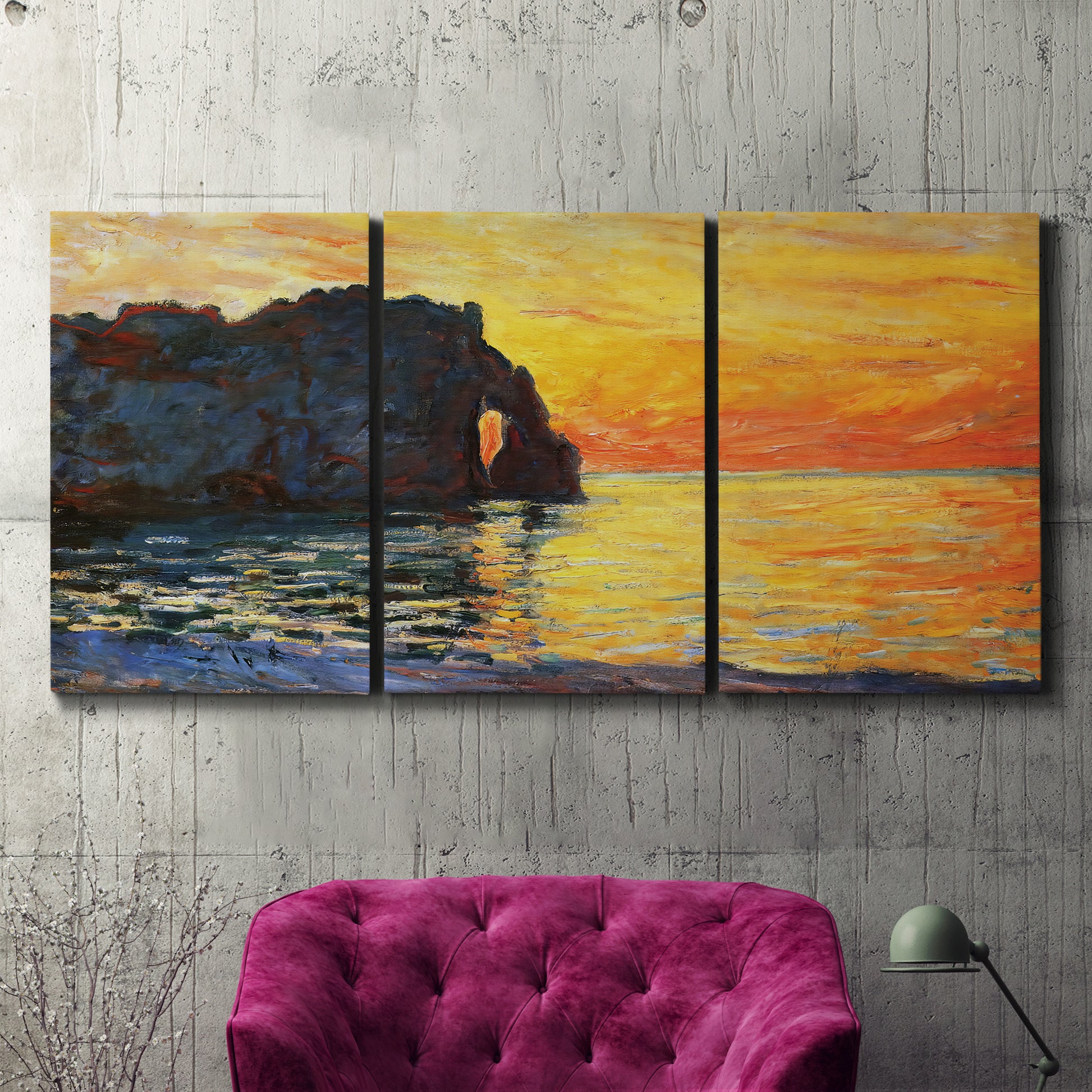 Three-panel canvas wall art featuring arched coastal cliff above sea, displayed in a living room above a suede accent chair.