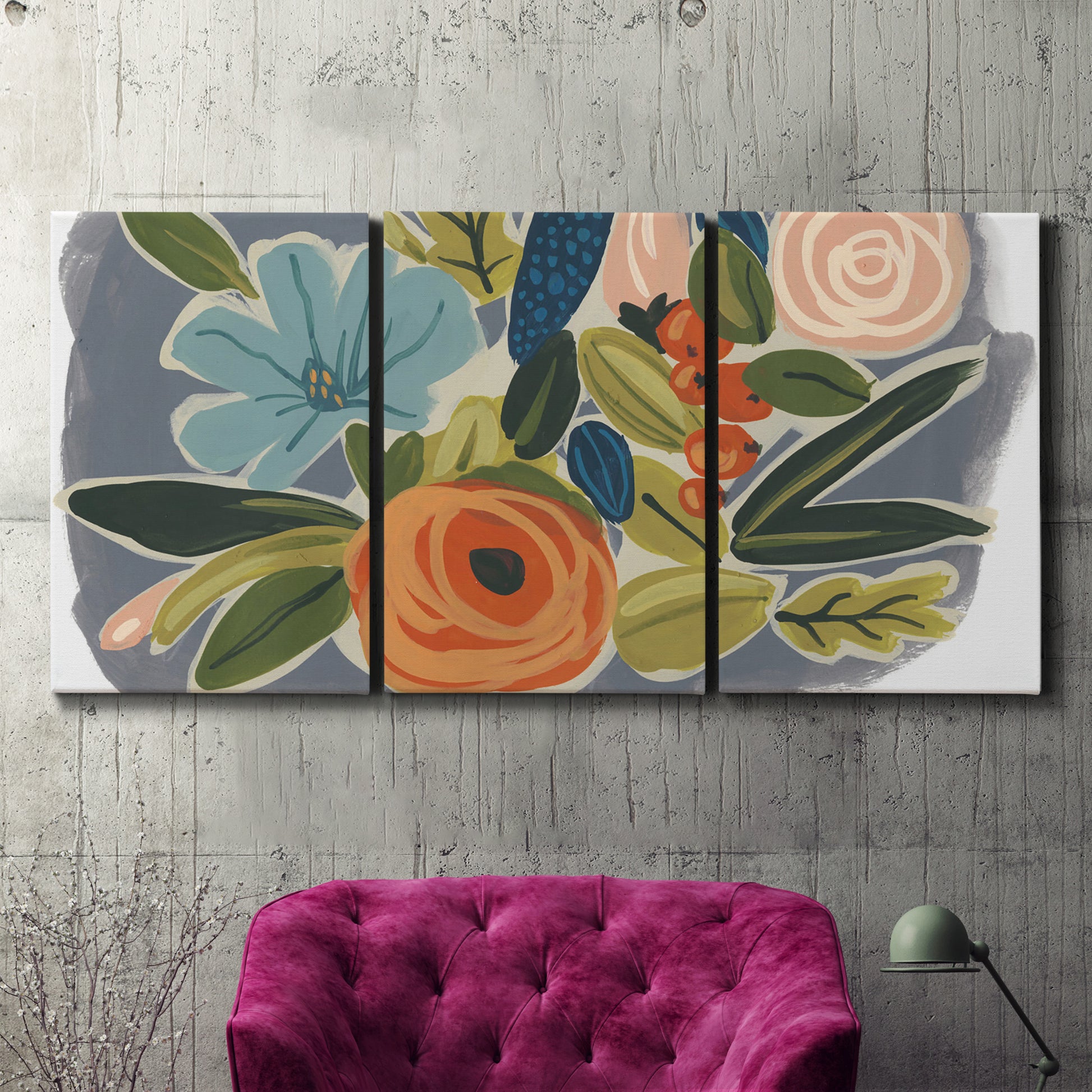 Three-panel canvas wall art featuring colorful botanical illustration, displayed in a living room above a suede accent chair.