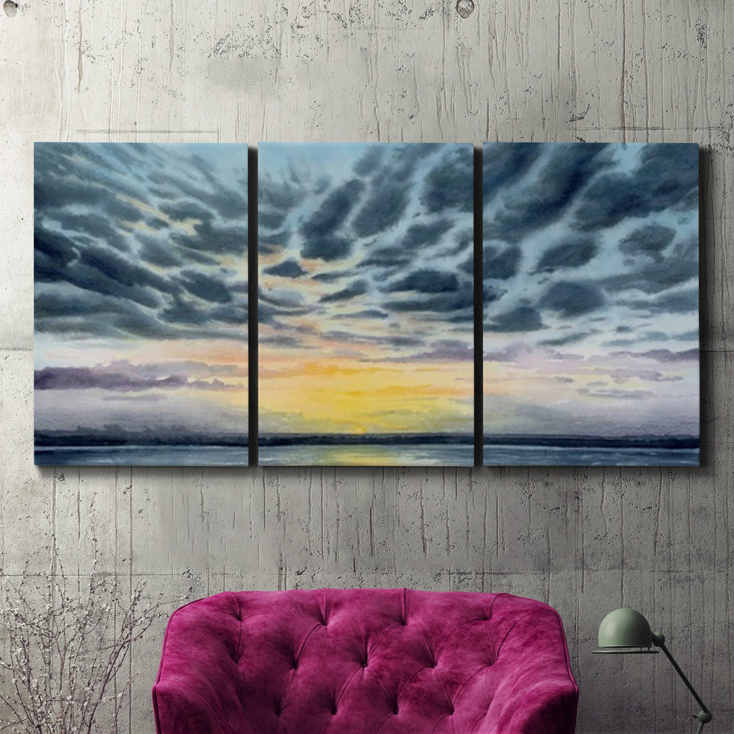 Three-panel canvas wall art featuring tropical coastal sunset over water, displayed in a living room above a suede accent chair.