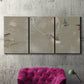 Three-panel canvas wall art featuring mid century terrazzo inspired abstraction, displayed in a living room above a suede accent chair.