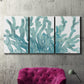 Three-panel canvas wall art featuring blue coral inspired watercolor, displayed in a living room above a suede accent chair.