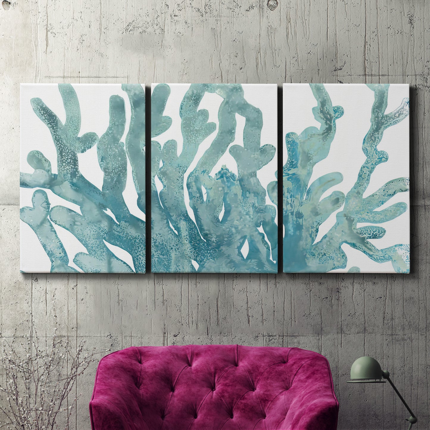 Three-panel canvas wall art featuring blue coral inspired watercolor, displayed in a living room above a suede accent chair.