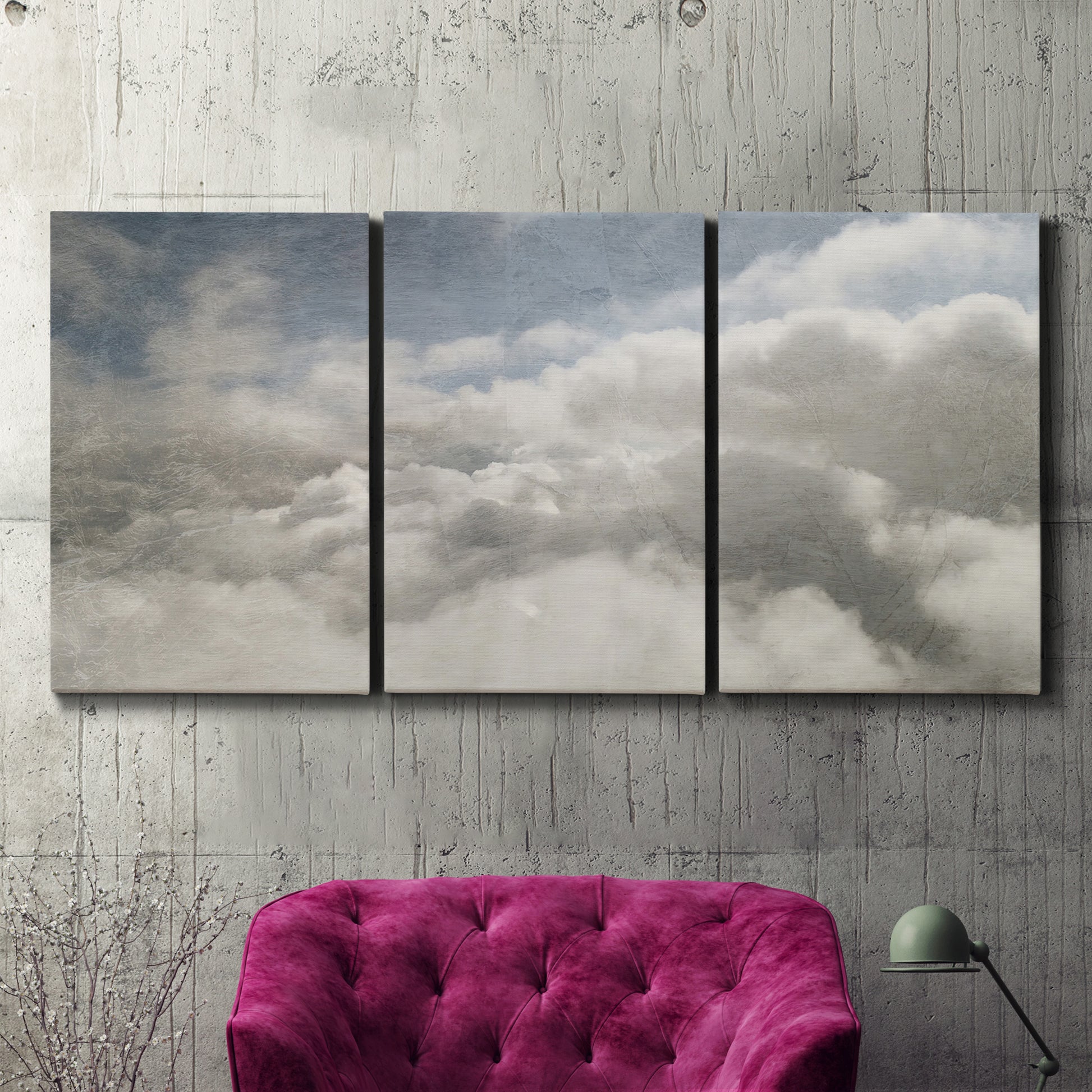 Three-panel canvas wall art featuring aerial landscape view photograph, displayed in a living room above a suede accent chair.