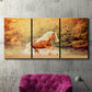 Three-panel canvas wall art featuring running horses captured in motion, displayed in a living room above a suede accent chair.