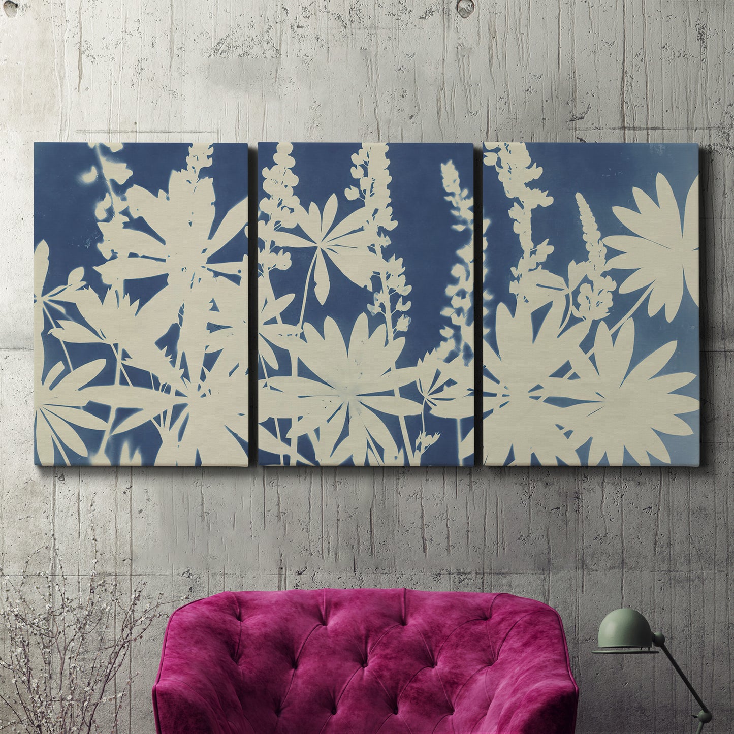 Three-panel canvas wall art featuring delicate lupine floral composition, displayed in a living room above a suede accent chair.