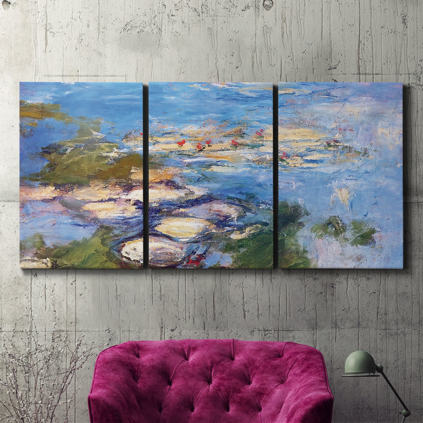 Three-panel canvas wall art featuring water lilies in blue and gold, displayed in a living room above a suede accent chair.