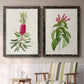 Set of two black barnwood framed canvas prints depicting two vintage botanical plate illustrations featuring pink flowering plant specimens above a sideboard in a cozy sitting room.