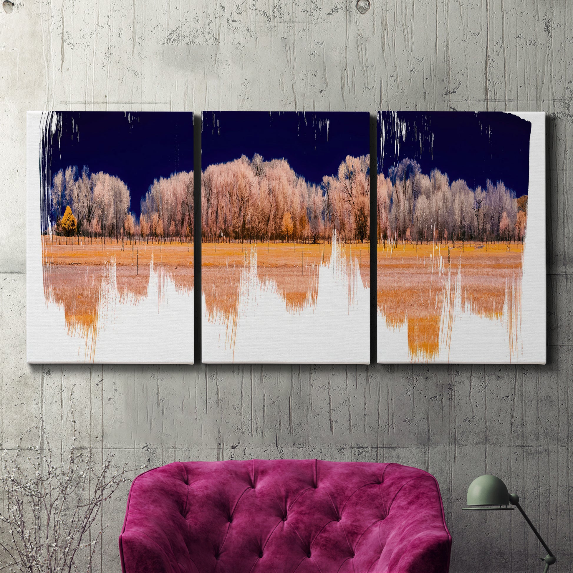 Three-panel canvas wall art featuring panoramic treeline landscape photograph, displayed in a living room above a suede accent chair.