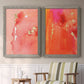 Set of two gray barnwood framed canvas prints depicting two glamorous fluid abstracts featuring luminous coral orange and pink color fields with gold flecks above a sideboard in a cozy sitting room.